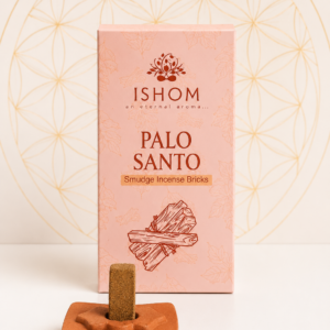 ISHOM Palo Santo Smudge Incense Bricks with terracotta holder and natural incense bricks displayed on a white table.