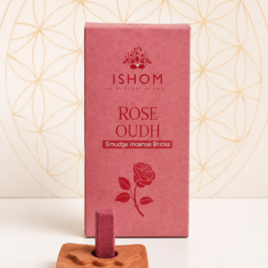 Ishom Rose Oudh Smudge Incense Bricks with terracotta holder and natural rose-coloured incense bricks displayed on a white tabletop.