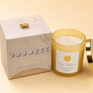 New Moon Manifestation Candle with Wild Orange fragrance and Clear Quartz crystals in a yellow frosted glass jar