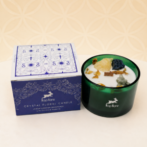 Hop Hare Crystal Magic Candle The Sun with Citrine and Sodalite crystals in a green glass jar.