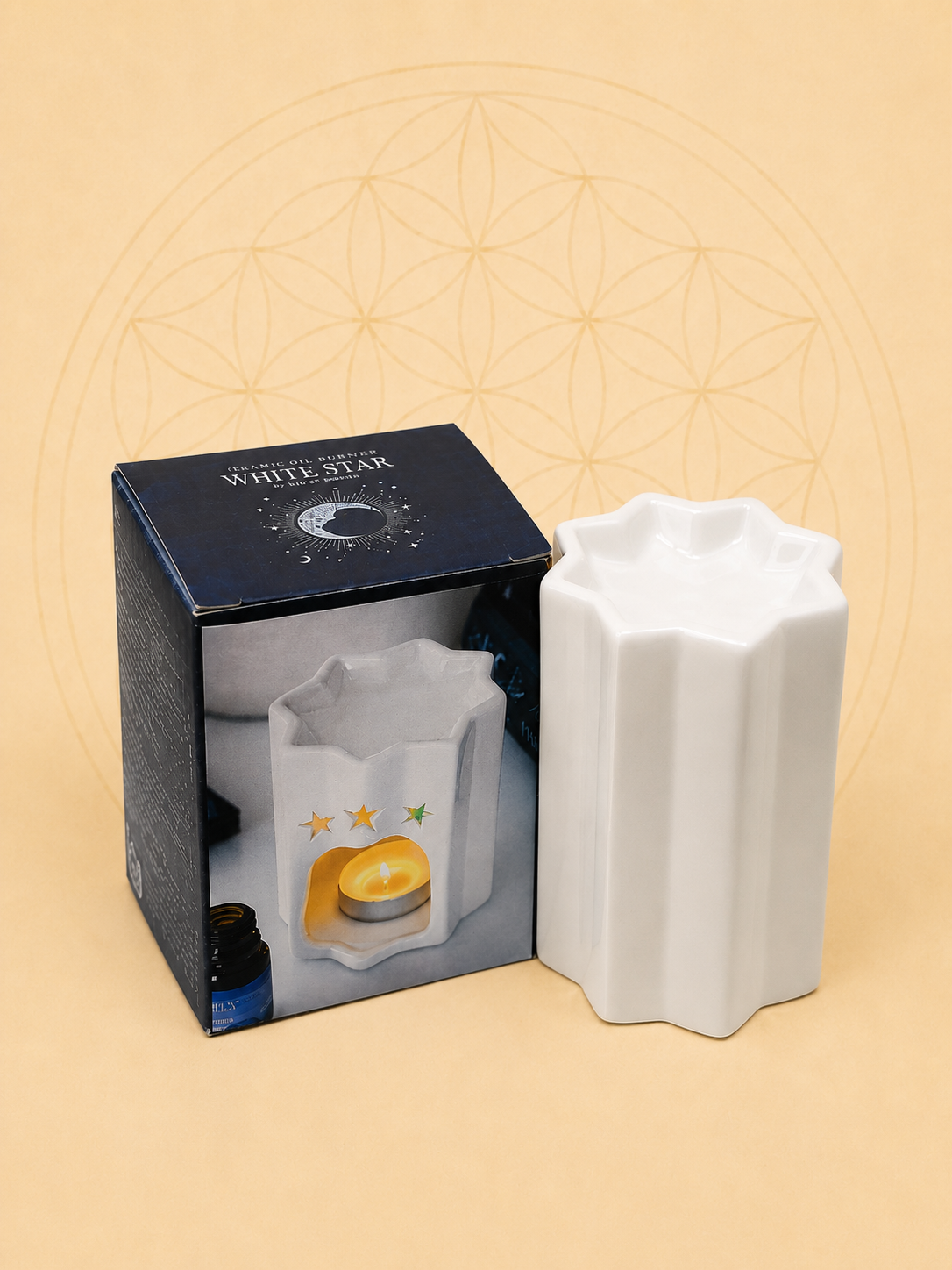 White ceramic star-shaped oil burner with gift box on a soft beige background, suitable for fragrance oils.