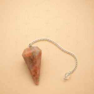 Peach Moonstone crystal pendulum with silver chain for dowsing and energy healing.